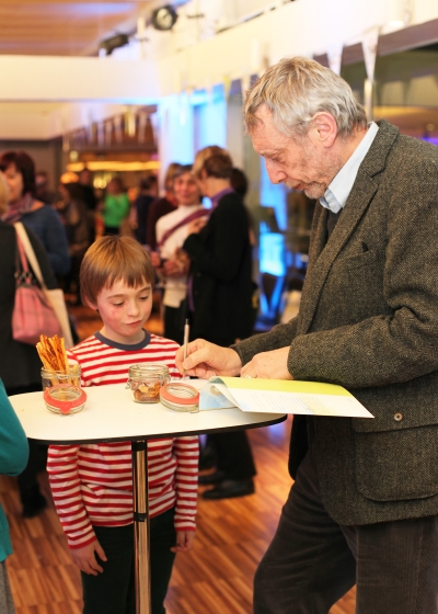 Michael Rosen signs a copy of We're Going on a Bear Hunt 